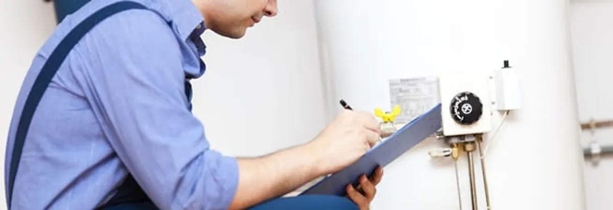 Water heater repair technician inspecting the unit and recording service notes in San Francisco, CA